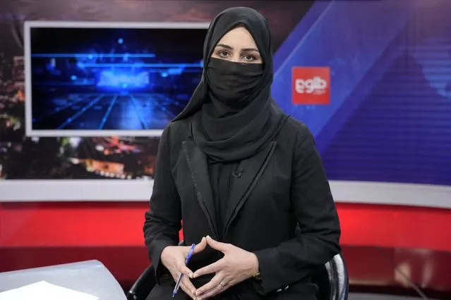 TV anchor Khatereh Ahmadi wears a face covering as she reads the news on TOLO NEWS, in Kabul, Afghanistan, Sunday, May 22, 2022. Afghanistan's Taliban rulers have begun enforcing an order requiring all female TV news anchors in the country to cover their faces while on-air. The move Sunday is part of a hard-line shift drawing condemnation from rights activists. (Photo by Ebrahim Noroozi/AP Photo)