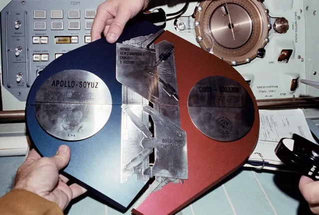 The Apollo-Soyuz Test Project (ASTP) Commemorative Plaque is assembled in the Soviet Soyuz Orbital Module during the joint U.S.-USSR Apollo-Soyuz Test Project docking mission in Earth orbit. The plaque is written both in English and Russian. 17-18 July 1975. (Photo by NASA)