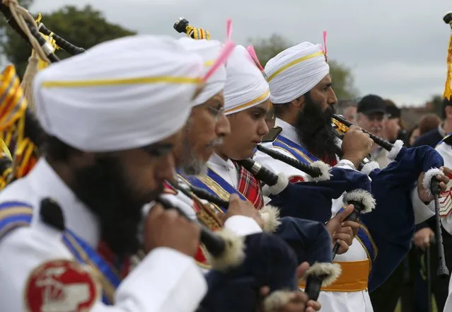 Members of the Sri Dasmesh Pipe Band from Malaysia warm up before competing in the annual World Pipe Band Championships at Glasgow Green, Scotland August 15, 2015. (Photo by Russell Cheyne/Reuters)