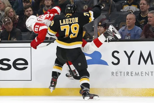 Boston Bruins' Jeremy Lauzon (79) checks Detroit Red Wings' Valtteri Filppula (51) during the first period of an NHL hockey game in Boston, Saturday, February 15, 2020. (Photo by Michael Dwyer/AP Photo)
