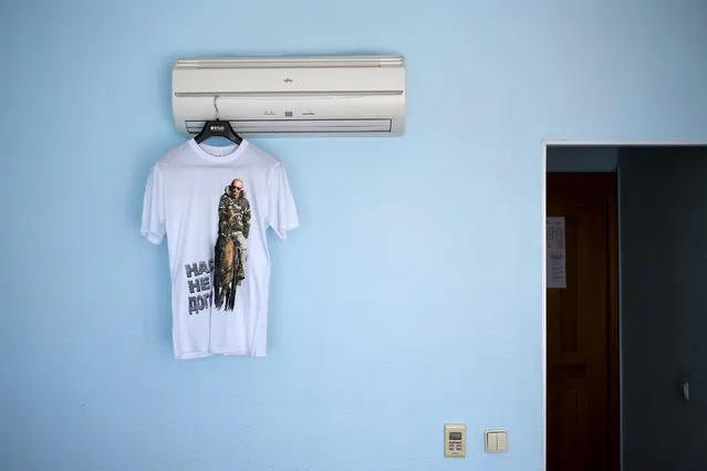 A t-shirt with a picture of Russian President Vladimir Putin and the text “They can't catch us” is seen in this photo illustration taken in a hotel room in Kazan, Russia, July 30, 2015. (Photo by Stefan Wermuth/Reuters)