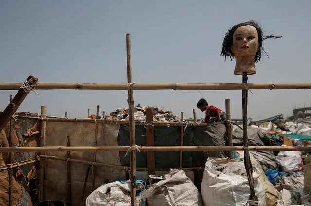 A boy picks out plastic bottles at a recycling yard in New Delhi, India, August 18, 2017. (Photo by Adnan Abidi/Reuters)