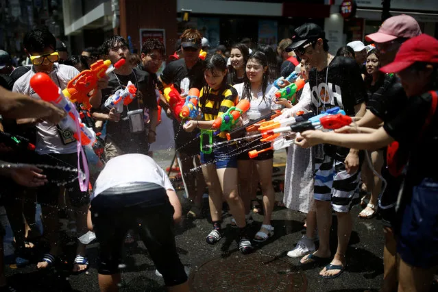 Participants play with water guns during the Sinchon Water Gun Festival in Seoul, South Korea, July 9, 2016. (Photo by Kim Hong-Ji/Reuters)