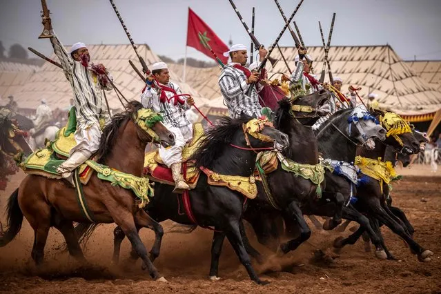 Moroccan horsemen perform traditional horse riding during a Moussem culture and heritage festival in the capital Rabat, on August 27,2022. (Photo by Fadel Senna/AFP Photo)