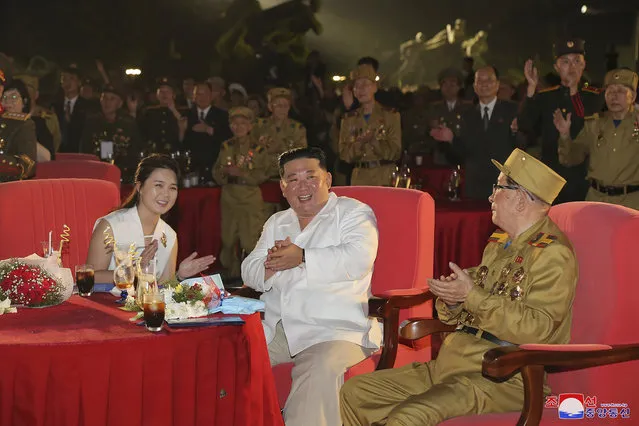In this photo provided by the North Korean government, North Korean leader Kim Jong Un, center, and his wife Ri Sol Ju attend a ceremony to mark the 69th anniversary of the signing of the ceasefire armistice that ends the fighting in the Korean War, in Pyongyang, North Korea Wednesday, July 27, 2022. Independent journalists were not given access to cover the event depicted in this image distributed by the North Korean government. The content of this image is as provided and cannot be independently verified. Korean language watermark on image as provided by source reads: “KCNA” which is the abbreviation for Korean Central News Agency. (Photo by Korean Central News Agency/Korea News Service via AP Photo)