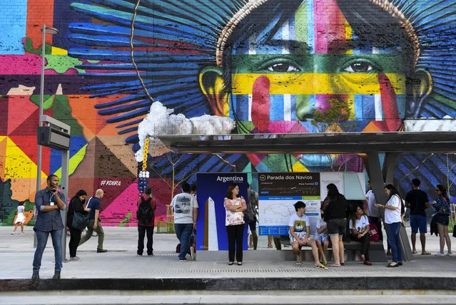 People wait for the new metro line train in the city center with a mural by the artist Kobra on August 2, 2016 in Rio De Janeiro, Brazil. (Photo by Jonathan Newton/The Washington Post)