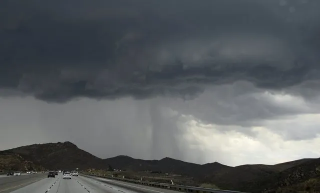 Dark monsoon storm cell dumps hail along the 14 Freeway during monsoon rains in the high desert area of Los Angeles County, California July 30, 2015. (Photo by Gene Blevins/Reuters)