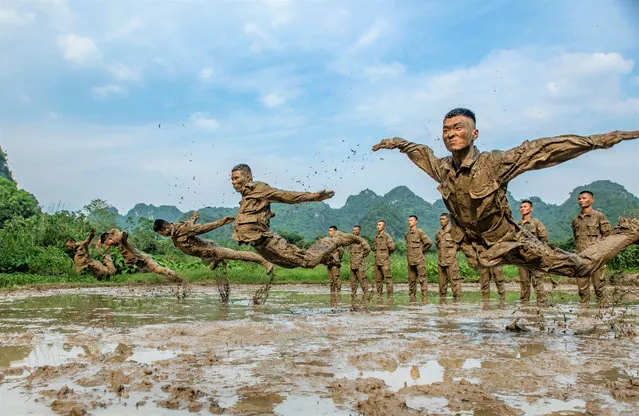 The officers and soldiers of the armed police carry out reverse training in the mire. Chongzuo, Guangxi, China, May 6, 2020. (Photo by Costfoto/Barcroft Media via Getty Images)