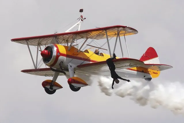 Veteran stuntwoman (wing walker) Jane Wicker and her pilot, Charlie Schwenker perform at Sun 'n Fun airshow in Lakeland, Florida, March 29, 2012. (Photo by Jon Ross Photography/Reuters)
