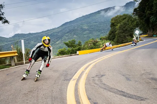 A group of young university students between the ages of 17 and 21 practice an extreme sport called longboarding, which consists of descending on skating boards on roads full of trucks and cars, in the municipality of Facatativa, Cundinamarca, Colombia on December 16, 2021. In their dangerous descents they reach speeds of up to 100 km per hour, every week they train and dream of competing for one day in the European or American leagues because in Colombia it is practiced informally. (Photo by Yair Suarez/Anadolu Agency via Getty Images)