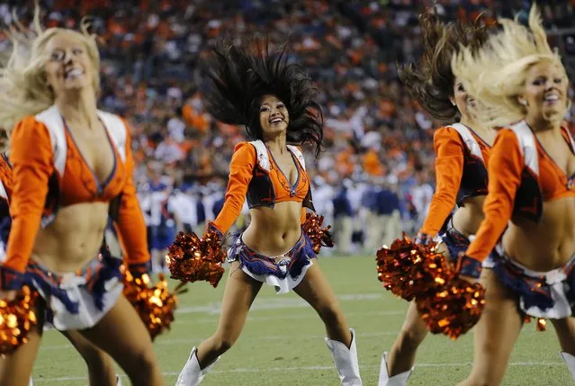 The Denver Broncos cheerleaders perform during the first half of an NFL preseason football game against the Seattle Seahawks, Thursday, August 7, 2014, in Denver. (Photo by Jack Dempsey/AP Photo)