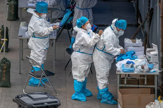 Medical workers wearing full protective suits prepare to test people for Covid-19 at a makeshift coronavirus testing center, in Beijing, China, 17 June 2020. Beijing has given COVID-19 nucleic acid tests to 356,000 people since 13 June, according to the city's government officials, as the number of new coronavirus cases is continuing to increase in the city. (Photo by Roman Pilipey/EPA/EFE)