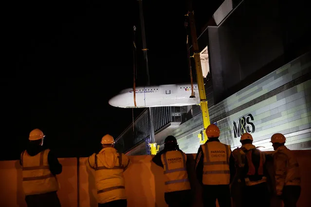 The 16 tonne fuselage section of a British Airways branded Airbus A319 is lifted over 100ft by crane into KidZania London on October 4, 2014 in London, England. Opening in early 2015 at Westfield London, KidZania will be a 75,000 sq ft life like city where children can learn real life skills, such as being a pilot in a fun and safe environment. KidZania London will be the 17th KidZania to open globally. (Photo by Matthew Lloyd/Getty Images for KidZania London)