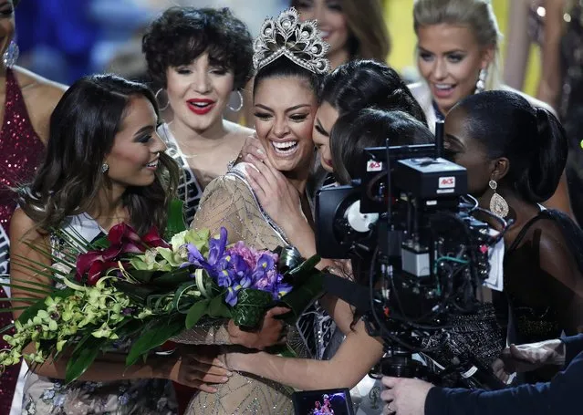 The new Miss Universe Demi-Leigh Nel-Peters, center, cries after winning at the Miss Universe pageant Sunday, November 26, 2017, in Las Vegas. (Photo by John Locher/AP Photo)