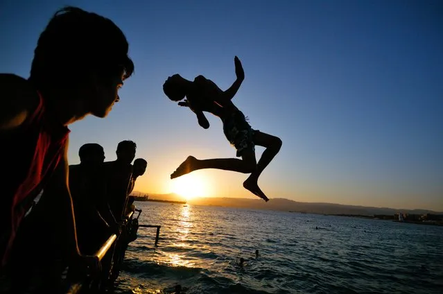“Jump!” A teenager jumping into the red sea from a pier in Aqaba. Photo location: Jordan. (Photo and caption by Ulrich Lambert/National Geographic Photo Contest)