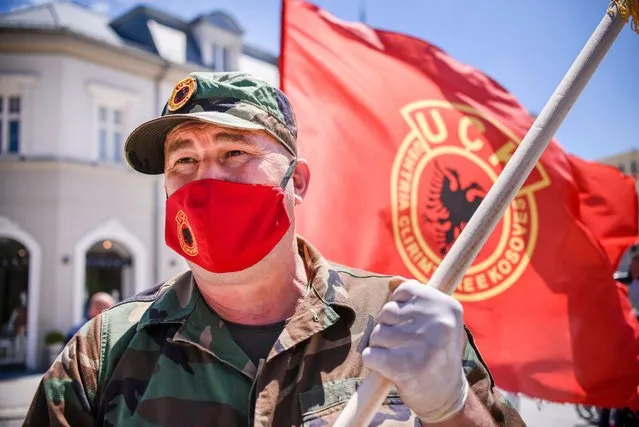 A Kosovo Liberation Army (KLA) veteran with a face mask depicting the KLA Logo takes part in a protest in Pristina on July 9, 2020 against the indictments of Kosovo President and other former KLA members accused of crimes against humanity and war crimes by the Prosecutor of the Specialist Chambers for Kosovo, an international tribunal based in The Hague. (Photo by Armend Nimani/AFP Photo)