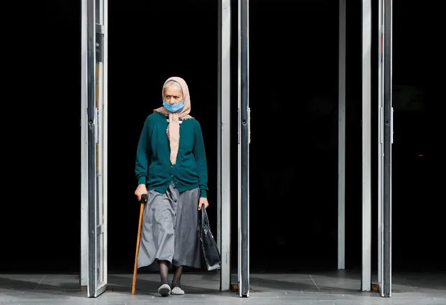 An elderly woman wearing a protective face mask amid the outbreak of the coronavirus disease (COVID-19) walks out of a metro station in Kyiv, Ukraine on July 15, 2020. (Photo by Gleb Garanich/Reuters)