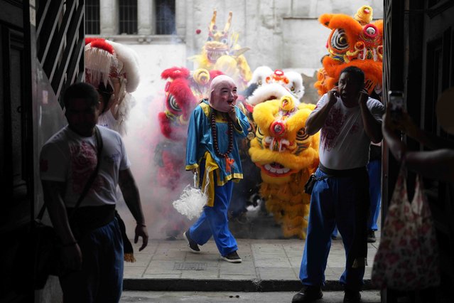 Dancers in lion, dragon and a pig costumes perform to mark the Chinese New Year, the Year of the Wooden Dragon, in Lima, Peru, Friday, February 9, 2024. (Photo by Martin Mejia/AP Photo)