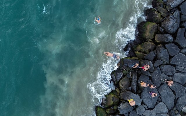Members of the “Conquerors of Sarayburnu” jump in the water for their daily routine of swimming in the Bosphorus' cold waters during a rainy 1-degree Celsius morning in Istanbul, Turkey, 11 February 2025. (Photo by Erdem Sahin/EPA/EFE)