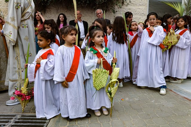 Palestinian Christian children attend the Palm Sunday mass at the Greek Orthodox Church of Saint Porphyrius in Gaza City on April 13, 2025. (Photo by Omar Al-Qattaa/AFP Photo)