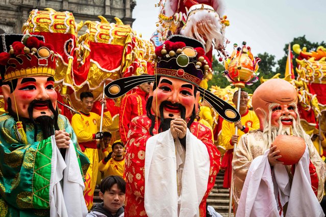A human puppet of Tsai Shen Yeh, the God of Wealth, parades in front of the St. Paul's Ruins during celebrations in Macau on February 10, 2024, on the first day of the Lunar New Year of the Dragon. (Photo by Eduardo Leal/AFP Photo)