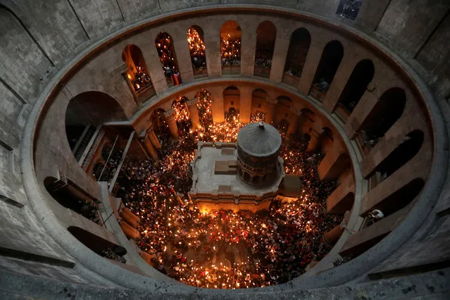 Worshippers hold candles as they take part in the Christian Orthodox Holy Fire ceremony at the Church of the Holy Sepulchre in Jerusalem's Old City, April 15, 2017. (Photo by Ammar Awad/Reuters)