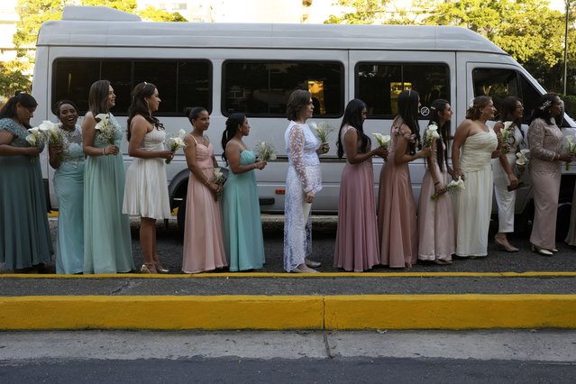 Brides stand in line as they arrive for a mass wedding ceremony at Altamira square on Valentine's Day, in Caracas, Venezuela, Friday, February 14, 2025. (Photo by Matias Delacroix/AP Photo)