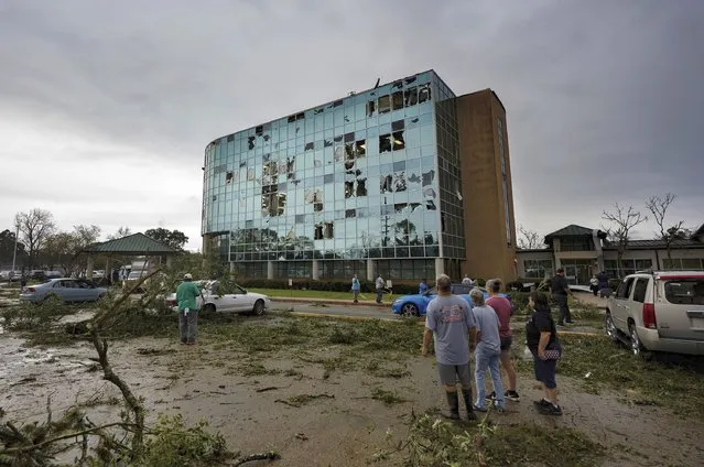 People survey damage following a tornado at the Iberia Medical Center, Wednesday, December 14, 2022, in New Iberia, La. (Photo by Leslie Westbrook/The Times-Picayune/The New Orleans Advocate via AP Photo)