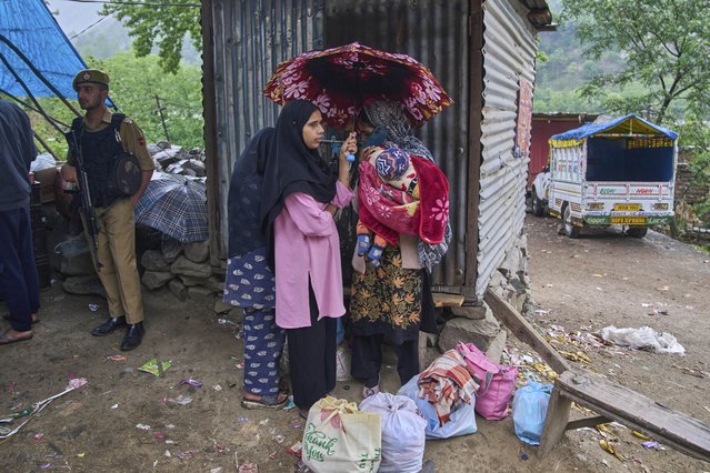 A group of Kashmiri village women wait for transportation as they leave following overnight shelling from Pakistan at Gingal village in Uri district, Indian controlled Kashmir, Friday, May 9, 2025. (Photo by Dar Yasin/AP Photo)