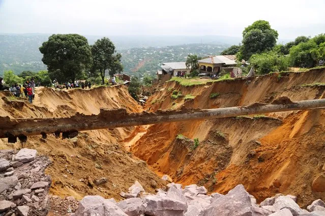 A view of a seriously damaged road after heavy rains caused floods and landslides, on the outskirts of Kinshasa, Democratic Republic of Congo on December 14,2022. (Photo by Justin Makangara/Reuters)