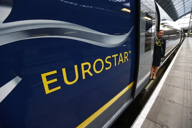 A Eurostar employee poses with their new Siemens e320 train at St Pancras station in central London, November 13, 2014. (Photo by Andrew Winning/Reuters)