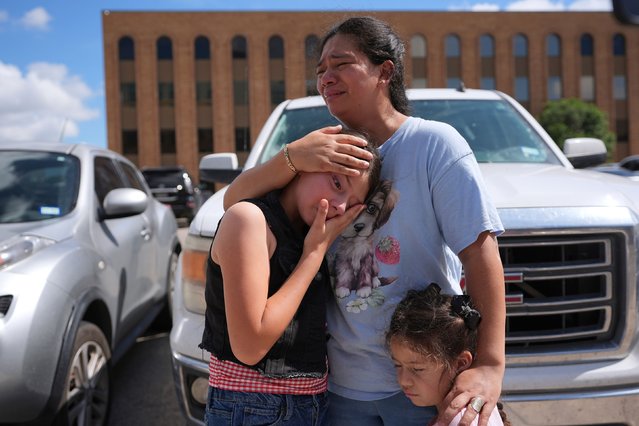 Narel Lopez comforts her daughters after her husband and a son were detained and taken away in a bus following an appearance at an immigration court in San Antonio on Wednesday, June 25, 2025. (Photo by Eric Gay/AP Photo)