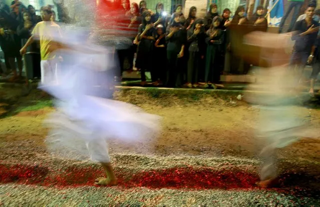 Shi'ite Muslims walk on hot coals at a ceremony during the Ashura festival at a mosque in central Yangon October 21, 2015. (Photo by Soe Zeya Tun/Reuters)