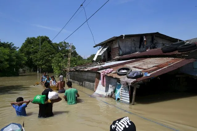 Residents travel across floodwaters a week after typhoon Koppu battered Calumpit town, Bulacan province, north of Manila October 24, 2015. (Photo by Romeo Ranoco/Reuters)