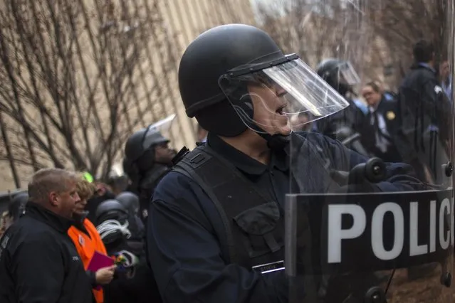 Police in riot gear ask protesters, who were demanding justice for Michael Brown, to stay back as they make arrests for disrupting traffic near the Edward Jones Dome, the site of an NFL football game between the St. Louis Rams and the Oakland Raiders, in downtown St. Louis, Missouri November 30, 2014. (Photo by Adrees Latif/Reuters)