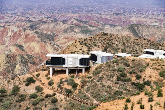 A view of space capsule homestay built on rolling hills at the Shuimo Danxia scenic spot on August 1, 2025 in Lanzhou, Gansu Province of China. The space capsule homestay built against the rolling hills offers visitors a unique experience as if they were on Mars. (Photo by VCG/VCG via Getty Images)