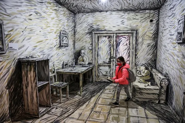 A girl walks inside a room as she visits the “Tel Aviv Pop-Up Museum”, a temporary art museum in two condemned Tel Aviv residential buildings where the works of 150 artists and designers are displayed, before the buildings are demolished in Tel Aviv Israel on February 1, 2022. (Photo by Nir Elias/Reuters)