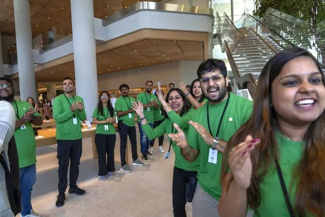 Apple retail employees applaud at the beginning of a press preview of India's first Apple Store in Mumbai, India, Monday, April 17, 2023. Apple will open its first retail store in India in Mumbai on Tuesday. (Photo by Rafiq Maqbool/AP Photo)