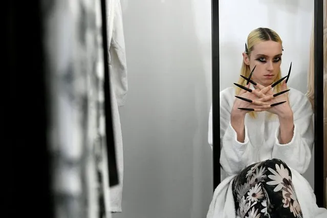 A model gets ready backstage ahead of Rochas Fall-Winter 2022/2023 Women's ready-to-wear collection show during Paris Fashion Week in Paris, France, March 2, 2022. (Photo by Piroschka van de Wouw/Reuters)