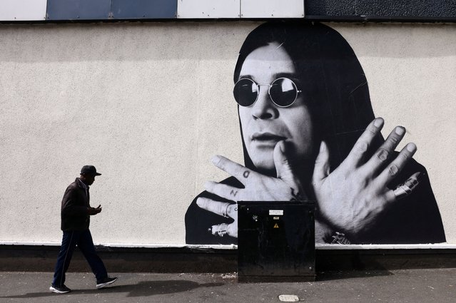 A man passes by a mural of Ozzy Osbourne, the former Black Sabbath frontman, ahead of the funeral cortege, in Birmingham, Britain, on July 30, 2025. (Photo by Jack Taylor/Reuters)