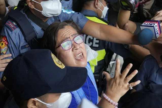 Detained former opposition Senator Leila de Lima, center, reacts as she goes out of the Muntinlupa trial court on Friday, May 12, 2023 in Muntinlupa, Philippines. De Lima was acquitted by the Muntinlupa court in one of her drug related charges she says were fabricated by former President Rodrigo Duterte and his officials in an attempt to muzzle her criticism of his deadly crackdown on illegal drugs. (Photo by Aaron Favila/AP Photo)