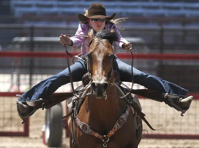Jimmie Smith, of McDale, Texas, competes during the annual Cheyenne Frontier Days slack rodeo barrel racing competition on Monday, July 16, 2018, at Frontier Park Arena in Cheyenne, Wyo. (Photo by Jacob Byk/The Wyoming Tribune Eagle via AP Photo)