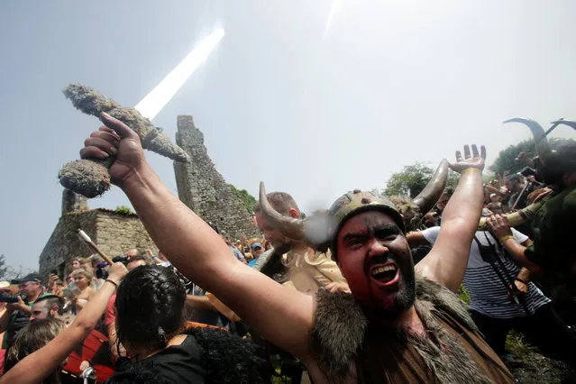 A man dressed up as a Viking shouts during the annual Viking festival of Catoira in north-western Spain on August 5, 2018. The festival re-enacts past Viking raids in the area and is celebrated annually on the first Sunday of August. (Photo by Miguel Vidal/Reuters)