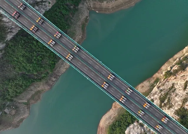 A static load test is carried out on the Jinfeng Wujiang Bridge in Guiyang, Guizhou Province, China, on the afternoon of May 21, 2023. In this load test, 48 35-ton trucks with a total weight of 1680 tons were used to check and evaluate whether the quality and working performance of the bridge were in conformity with the design. The Jinfeng Wujiang Bridge is 1473.5 meters in length, and the main bridge is 650 meters of single span simply supported steel truss girder suspension bridge. It is the first ultra-wide lane steel truss girder suspension bridge constructed by prefabricated parallel steel cable strands in Guizhou Province. (Photo credit should read Liu Qing/Future Publishing via Getty Images)