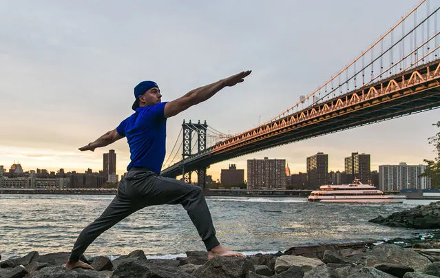 Yoga in front of the Brooklyn bridge, New York. (Photo by Kristina Kashtanova/Caters News)