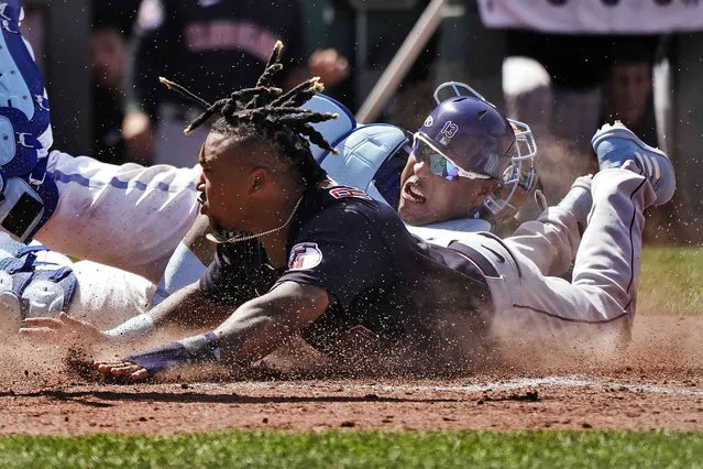 Cleveland Guardians' Jose Ramirez, front, beats the tag by Kansas City Royals catcher Salvador Perez to steal home during the tenth inning of a baseball game Thursday, June 29, 2023, in Kansas City, Mo. The Royals won 4-3 in ten innings. (Photo by Charlie Riedel/AP Photo)