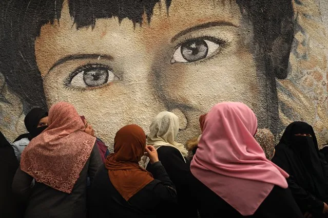 Palestinian women take part in a protest against the cuts in food aid distribution, outside the United Nations Relief and Works Agency (UNRWA) headquarters in Gaza City on March 18, 2021. (Photo by Mohammed Abed/AFP Photo)