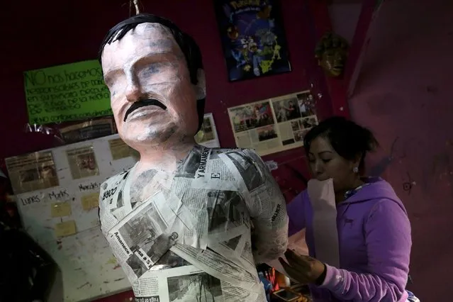 An artisan works on a pinata depicting the drug lord Joaquin "El Chapo" Guzman at a workshop in Reynosa, in Tamaulipas state, Mexico, January 13, 2016. (Photo by Daniel Becerril/Reuters)