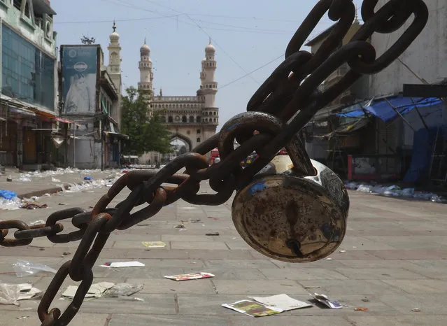 In this May 13, 2021 file photo, a road leading to landmark Charminar monument is closed during a lockdown imposed to curb the spread of the coronavirus in Hyderabad, India. (Photo by Mahesh Kumar A./AP Photo/File)