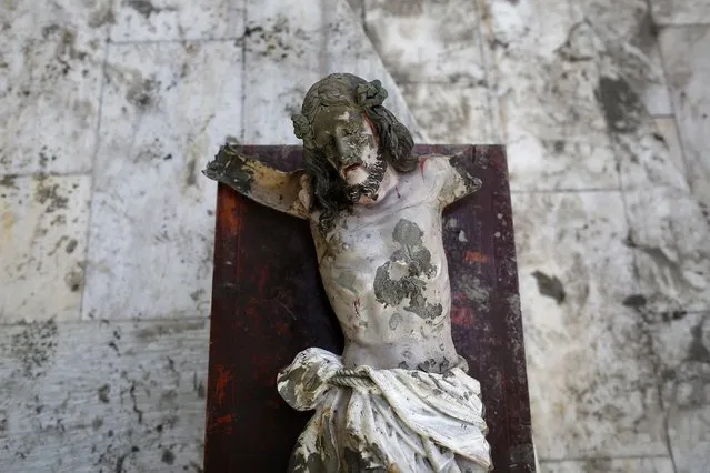 A damaged statue of Jesus Christ that was recovered from rubbles is placed in a church in an area wrecked by Typhoon Haiyan in Tacloban, on November 21, 2013. (Photo by Damir Sagolj/Reuters)